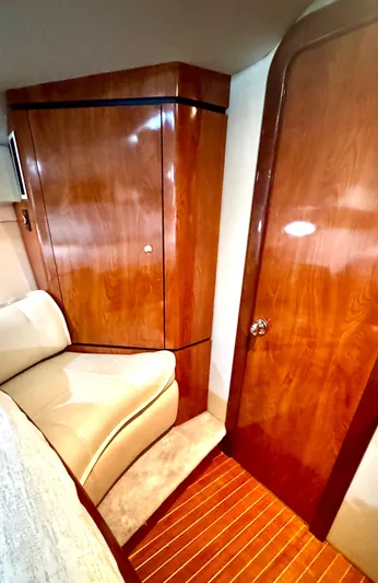  Yacht Photos Pics Interior of 2005 Fountain 48 Express Cruiser with polished wood finish and beige seating.