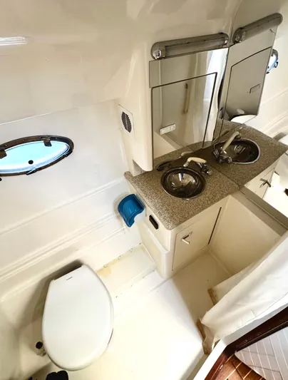  Yacht Photos Pics 2005 Fountain 48 Express Cruiser bathroom with sink, toilet, and mirror.