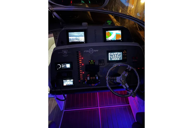  Yacht Photos Pics 2005 Fountain 48 Express Cruiser dashboard with illuminated controls and navigation screens.