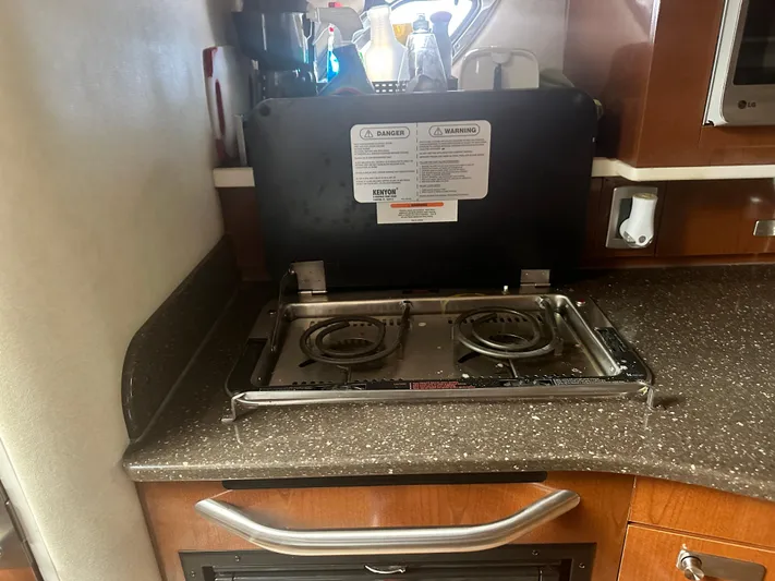  Yacht Photos Pics Compact kitchen stove in 2012 Sea Ray 330 Sundancer yacht interior.