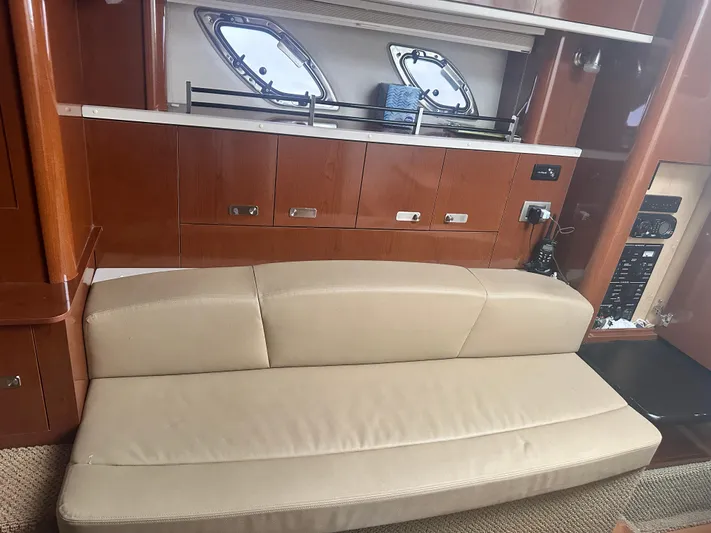  Yacht Photos Pics Interior of 2012 Sea Ray 330 Sundancer with beige seating and wooden cabinetry.