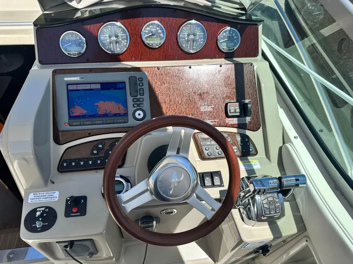  Yacht Photos Pics 2012 Sea Ray 330 Sundancer helm with GPS, gauges, and wood accents.