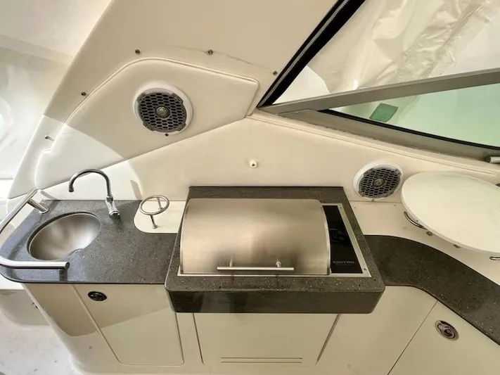  Yacht Photos Pics Outdoor kitchenette on 2012 Sea Ray 330 Sundancer with sink, grill, and speakers.
