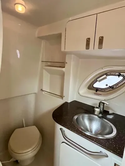  Yacht Photos Pics 2012 Sea Ray 330 Sundancer bathroom with sink, toilet, and storage cabinets.