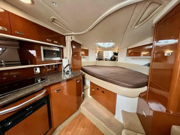  Yacht Photos Pics Interior of 2012 Sea Ray 330 Sundancer yacht with kitchen and bed.