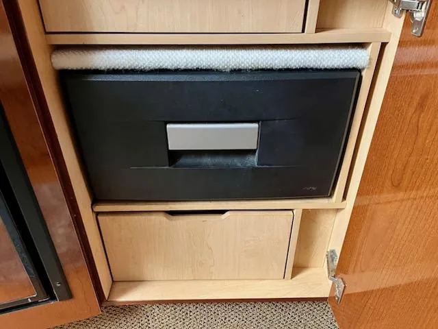  Yacht Photos Pics Cabinet interior of 2012 Sea Ray 330 Sundancer with built-in storage compartments.