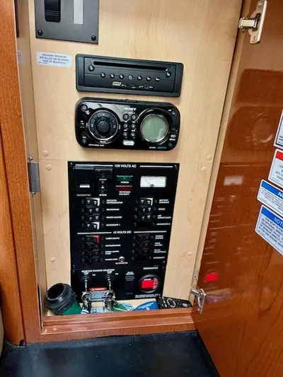  Yacht Photos Pics Control panel inside 2012 Sea Ray 330 Sundancer boat, featuring audio system and electrical switches.