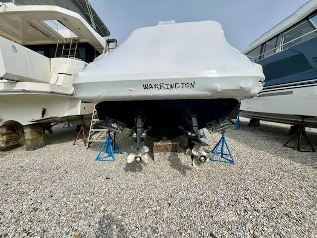  Yacht Photos Pics Covered 2012 Sea Ray 330 Sundancer boat on stands, labeled "Warrington," in a boatyard.