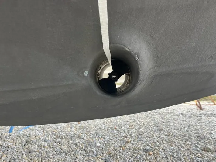  Yacht Photos Pics Close-up of a 2012 Sea Ray 330 Sundancer's bow thruster on a gravel surface.