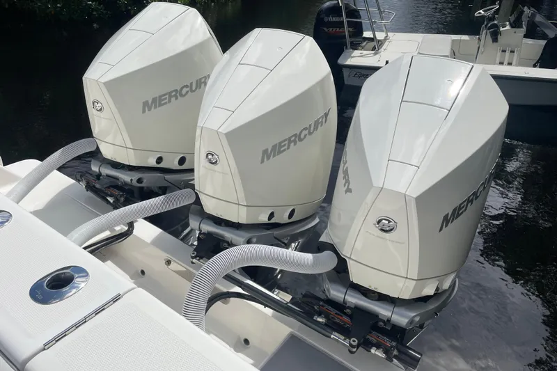  Yacht Photos Pics Triple Mercury outboard engines on a 2022 SeaVee 370z boat, docked by the water.