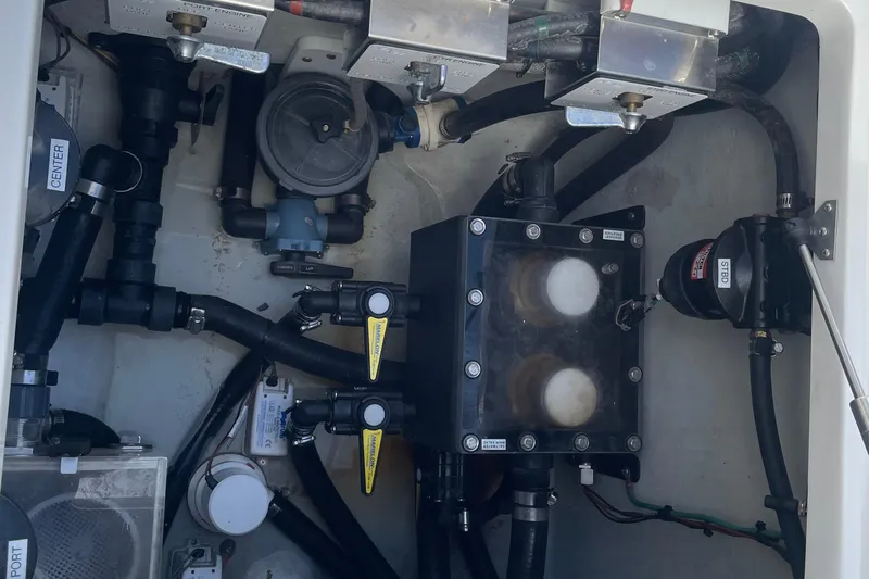  Yacht Photos Pics Engine compartment of a 2022 SeaVee 370z boat, showcasing mechanical components and plumbing.
