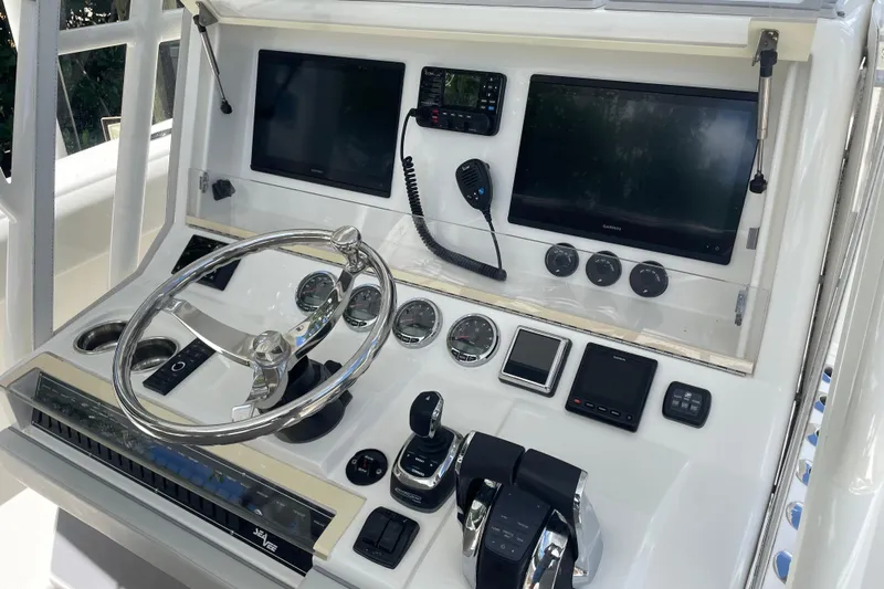  Yacht Photos Pics Control panel of 2022 SeaVee 370z boat with steering wheel and navigation screens.