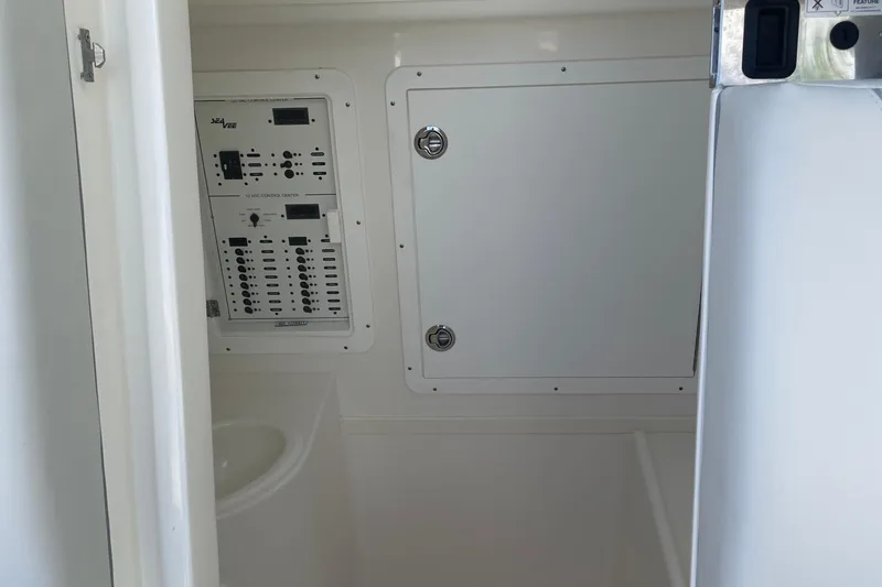  Yacht Photos Pics Interior view of 2022 SeaVee 370z boat's control panel and storage compartment.