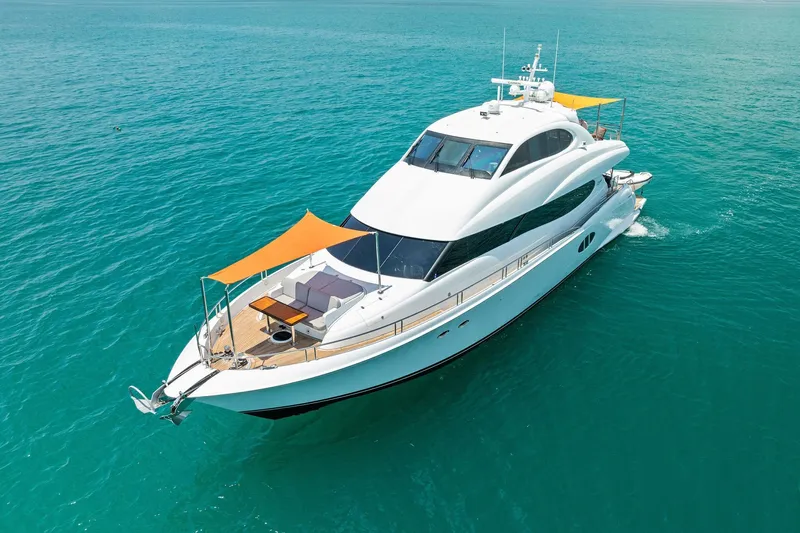 Voyager Yacht Photos Pics Luxurious 2006 Lazzara Skylounge yacht cruising on clear blue waters.