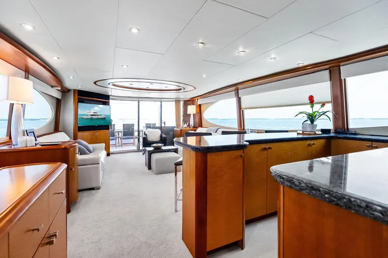 Voyager Yacht Photos Pics Luxurious interior of a 2006 Lazzara Skylounge yacht with elegant wood finishes and ocean views.