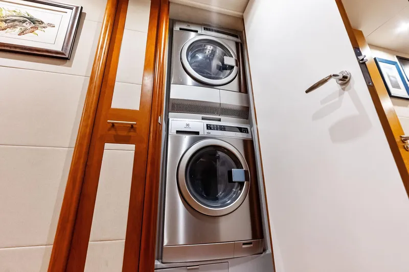Voyager Yacht Photos Pics Stacked washer and dryer in 2006 Lazzara Skylounge yacht interior.
