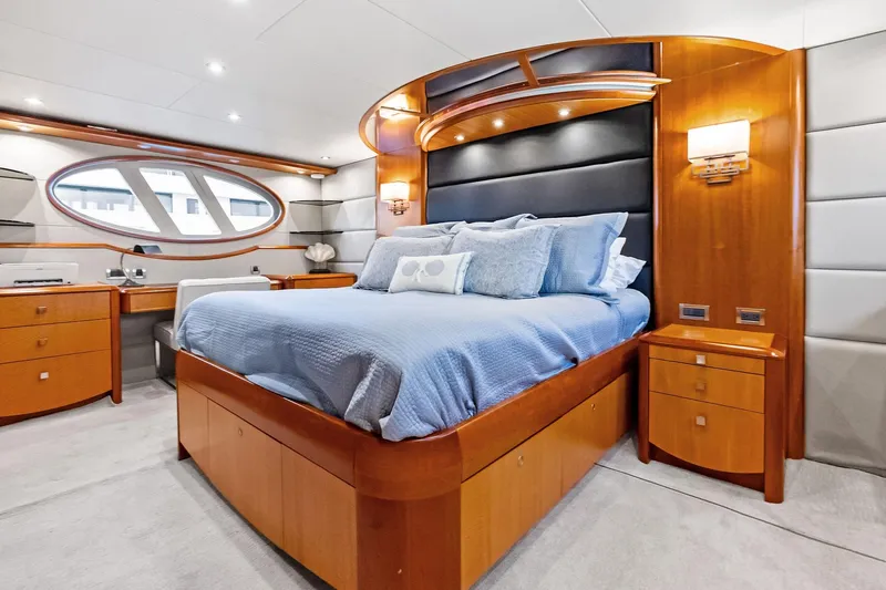 Voyager Yacht Photos Pics Luxurious 2006 Lazzara Skylounge yacht bedroom with elegant wood furnishings and modern design.