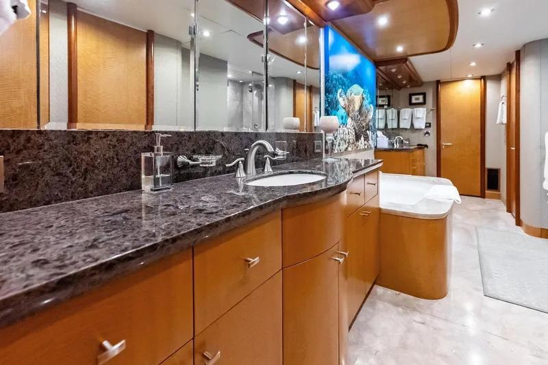 Voyager Yacht Photos Pics Luxurious bathroom in 2006 Lazzara Skylounge yacht with granite countertops and modern fixtures.