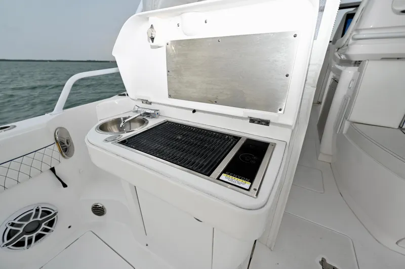  Yacht Photos Pics Outdoor kitchen on 2021 Intrepid 438 Evolution yacht with grill and sink.