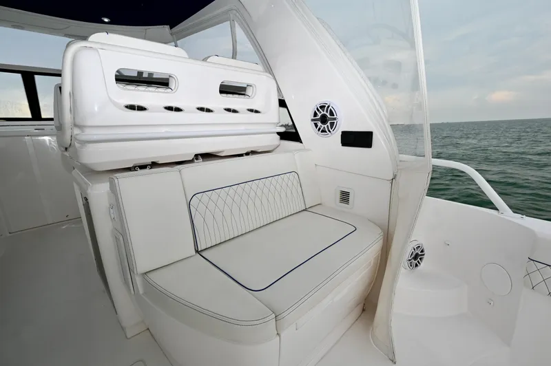  Yacht Photos Pics Luxurious seating on 2021 Intrepid 438 Evolution yacht, featuring elegant white upholstery.
