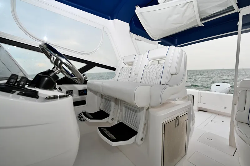  Yacht Photos Pics 2021 Intrepid 438 Evolution helm with white seating and ocean view.