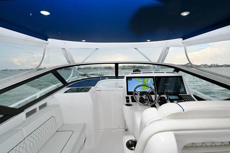 Yacht Photos Pics 2021 Intrepid 438 Evolution boat cockpit with modern navigation system and luxurious seating.