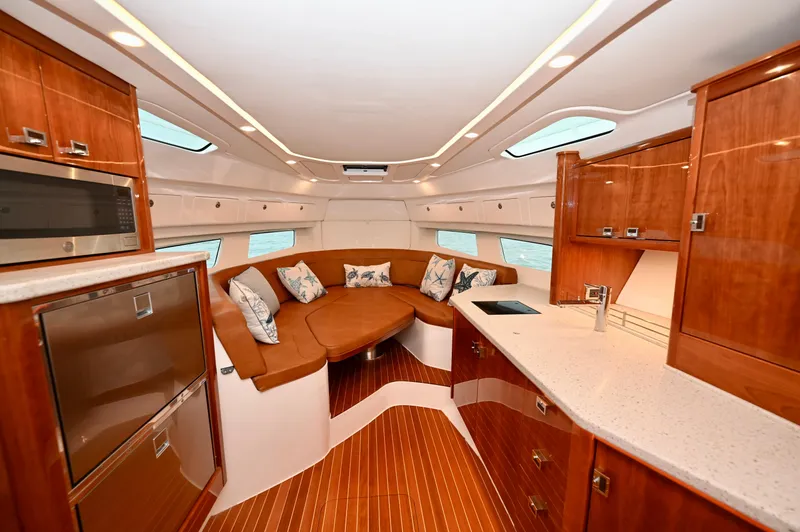  Yacht Photos Pics Luxurious interior of 2021 Intrepid 438 Evolution yacht with elegant wood finishes and modern amenities.