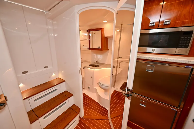  Yacht Photos Pics Luxurious 2021 Intrepid 438 Evolution yacht interior with modern kitchen and bathroom amenities.