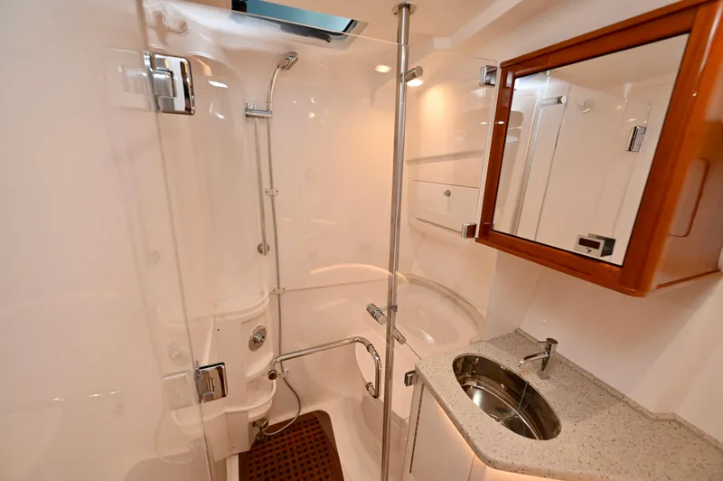  Yacht Photos Pics Luxurious bathroom in 2021 Intrepid 438 Evolution yacht with modern fixtures and elegant design.