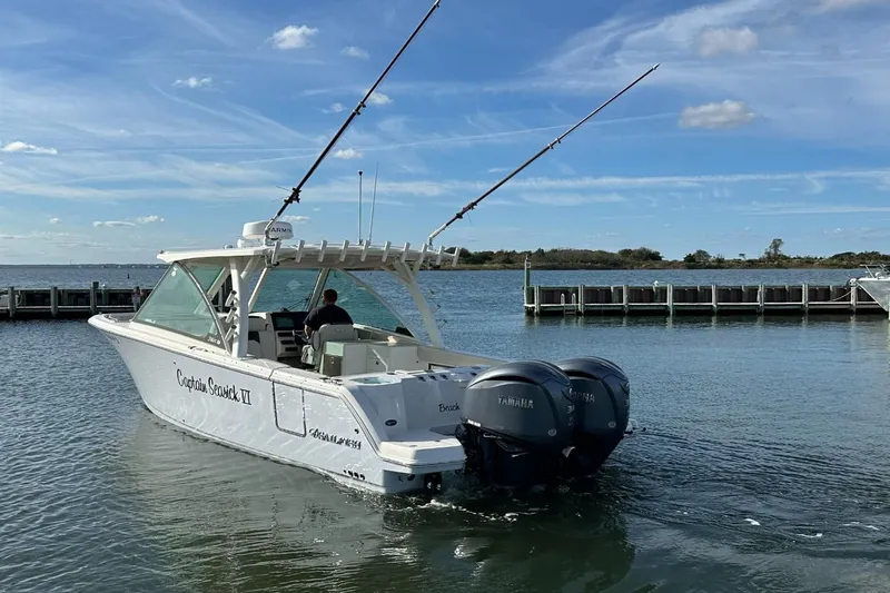  Yacht Photos Pics 2023 Sailfish 316 DC boat with dual Yamaha engines on a calm waterway.
