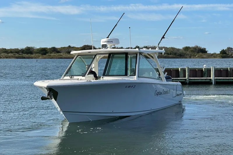  Yacht Photos Pics 2023 Sailfish 316 DC boat on water, equipped with Garmin technology.