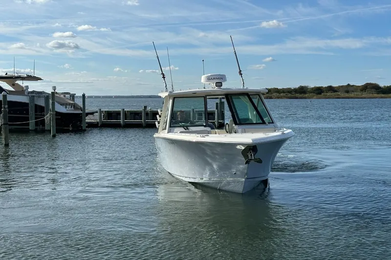  Yacht Photos Pics 2023 Sailfish 316 DC boat docked on a sunny day with clear skies.