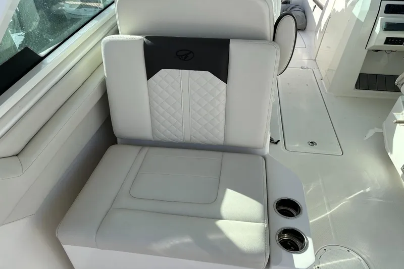  Yacht Photos Pics 2023 Sailfish 316 DC boat seat with cup holders, featuring white and gray upholstery.