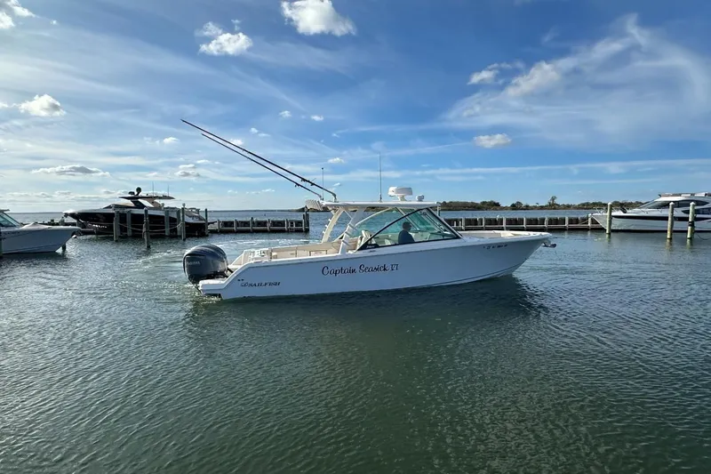  Yacht Photos Pics 2023 Sailfish 316 DC boat docked on calm water under a clear blue sky.