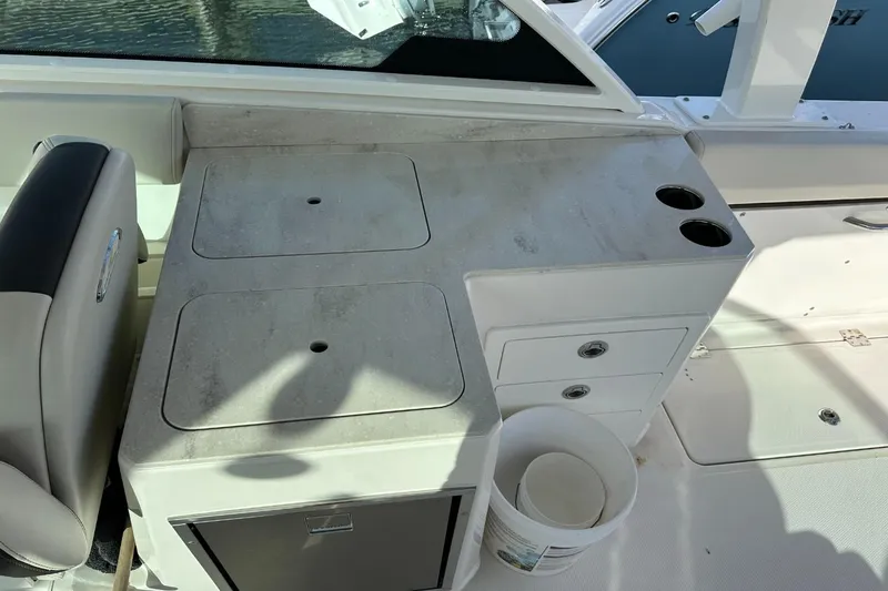  Yacht Photos Pics 2023 Sailfish 316 DC boat interior with storage compartments and cup holders.