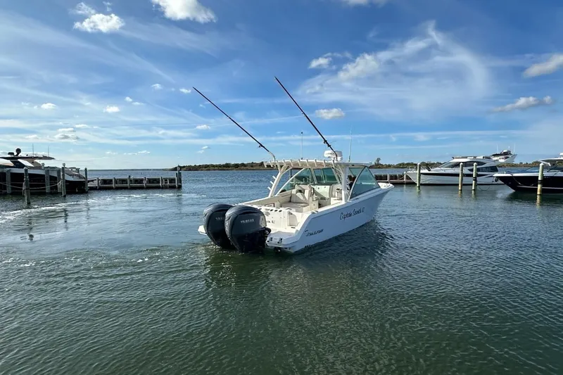  Yacht Photos Pics 2023 Sailfish 316 DC boat with twin Yamaha engines on a sunny day.