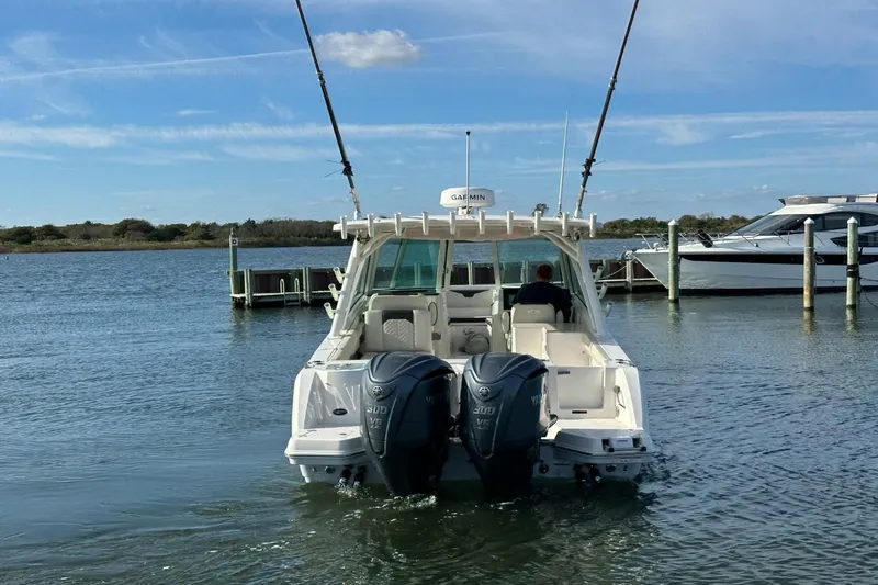  Yacht Photos Pics 2023 Sailfish 316 DC boat with dual engines on a calm waterway.