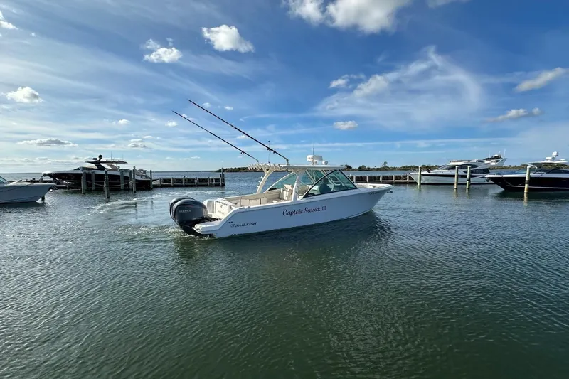  Yacht Photos Pics 2023 Sailfish 316 DC boat cruising on a sunny day near a marina.