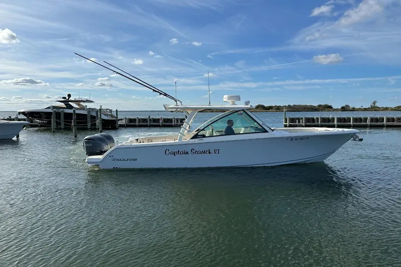  Yacht Photos Pics 2023 Sailfish 316 DC boat on water near dock, clear sky background.
