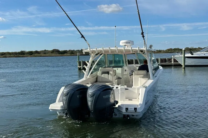  Yacht Photos Pics 2023 Sailfish 316 DC boat with dual Yamaha engines on calm water.