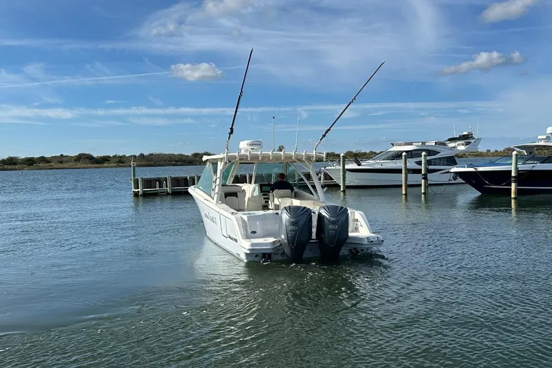  Yacht Photos Pics 2023 Sailfish 316 DC boat with dual engines docked in a marina.