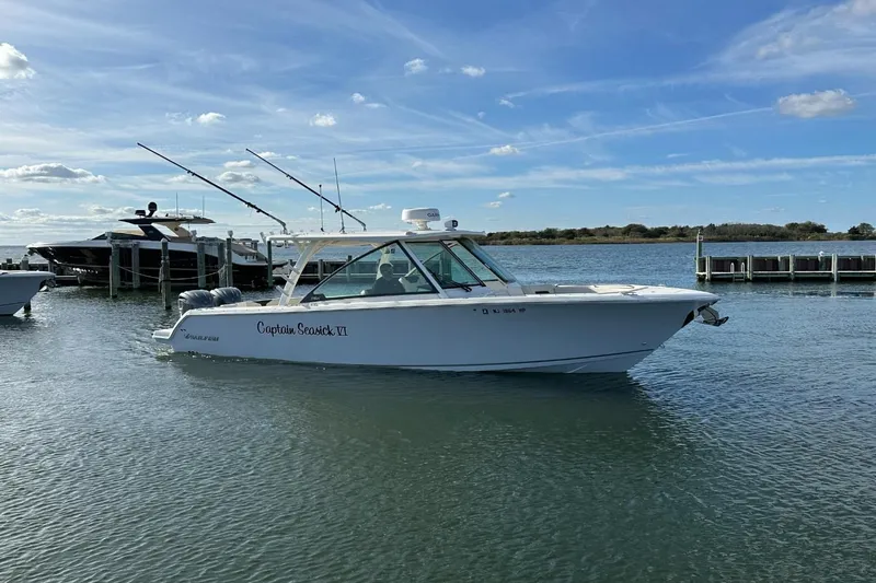  Yacht Photos Pics 2023 Sailfish 316 DC boat on water, clear sky, docked nearby.