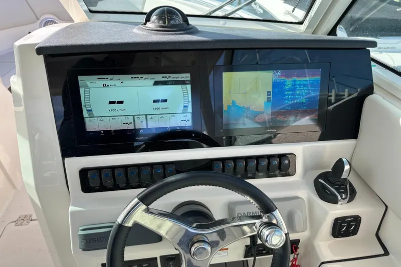  Yacht Photos Pics 2023 Sailfish 316 DC boat dashboard with Garmin displays and steering wheel.