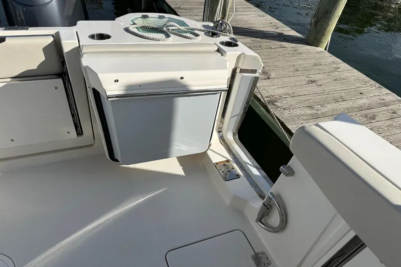  Yacht Photos Pics 2023 Sailfish 316 DC boat interior with seating and storage near dock.