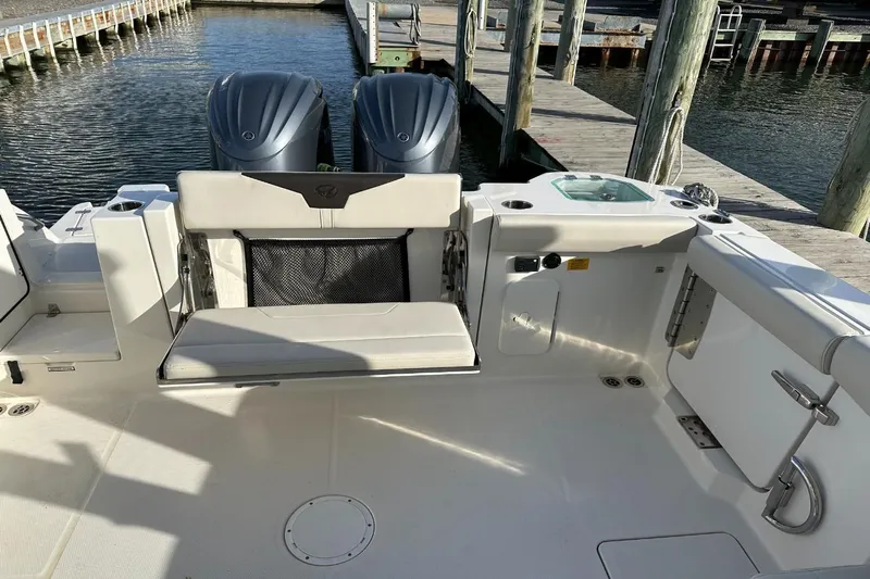  Yacht Photos Pics 2023 Sailfish 316 DC boat interior with seating and dual engines at dock.