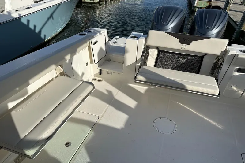  Yacht Photos Pics 2023 Sailfish 316 DC boat interior with seating and dual outboard motors.