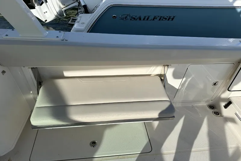  Yacht Photos Pics 2023 Sailfish 316 DC boat interior with foldable seat and storage compartment.