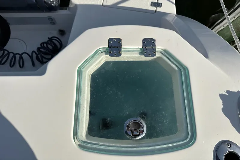  Yacht Photos Pics Livewell hatch on 2023 Sailfish 316 DC boat, featuring a glass lid and metal hinges.