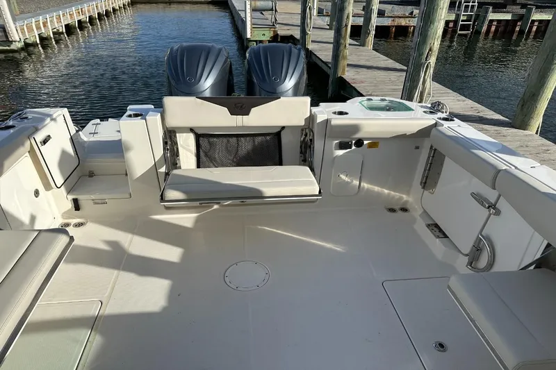  Yacht Photos Pics 2023 Sailfish 316 DC boat interior with seating and dual outboard motors at dock.