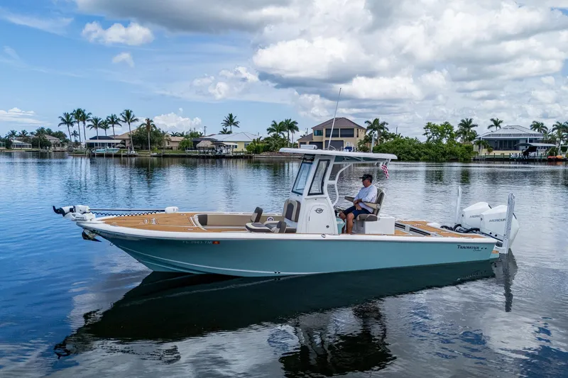 Yacht Photos Pics 2023 Tidewater 2700 Carolina Bay boat on calm water, with scenic background.